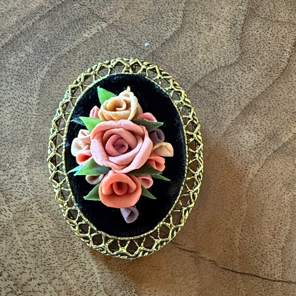 Vintage Floral Brooch with Gold Trim. Porcelain flowers on top of velvet backing